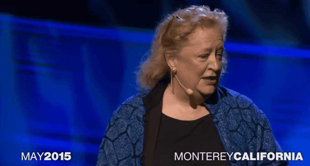 Margaret Heffernan speaking on stage in Monterey California for her TED Talk titled Forget the Pecking Order at Work.