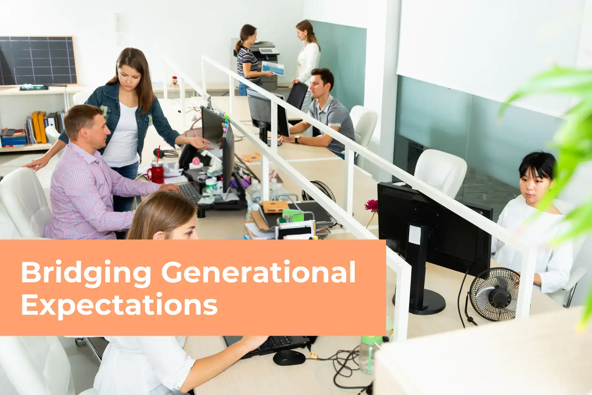 Diverse office workers sitting at rows of desks in a modern, open-plan workspace, overlaid with an orange box reading "Bridging Generational Expectations."