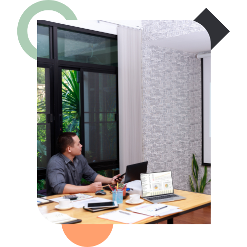 A professional at a desk focusing on data and strategy, representing the Alpha Performance System (APS) which strengthens individual behavior and response under pressure.