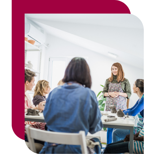 A facilitator leading a small group discussion with managers, illustrating Alpha Lupa’s ideal partnership with organizations focused on manager capability and team performance.