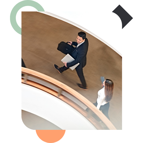 A high-angle view of professionals walking quickly through an office, illustrating the "busy-ness" and lack of focus that defines a Capacity Crisis.