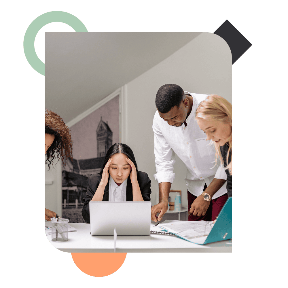 A concerned manager in a group meeting with colleagues reviewing data on a laptop, illustrating a performance gap and team challenges at Alpha Lupa.