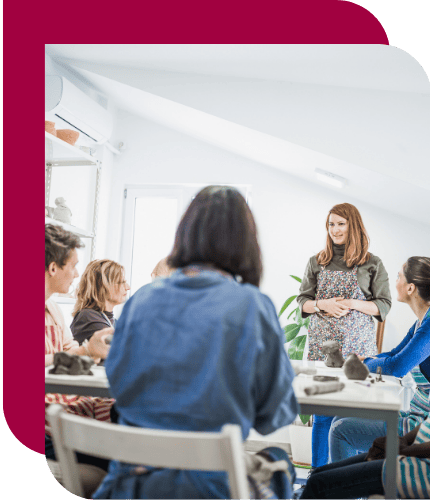 A facilitator leading a small group discussion with managers, illustrating Alpha Lupa’s ideal partnership with organizations focused on manager capability and team performance.